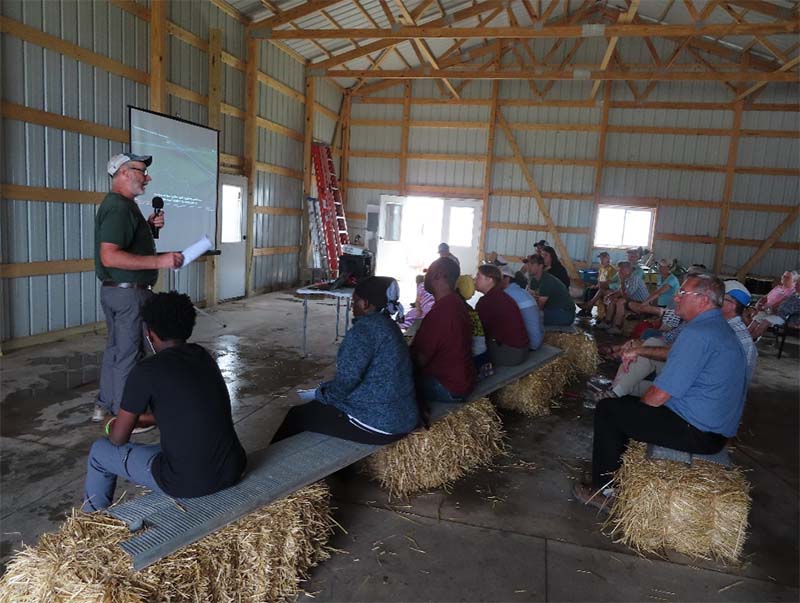 Farmer Calvin Franzenburg talks to field day attendees 